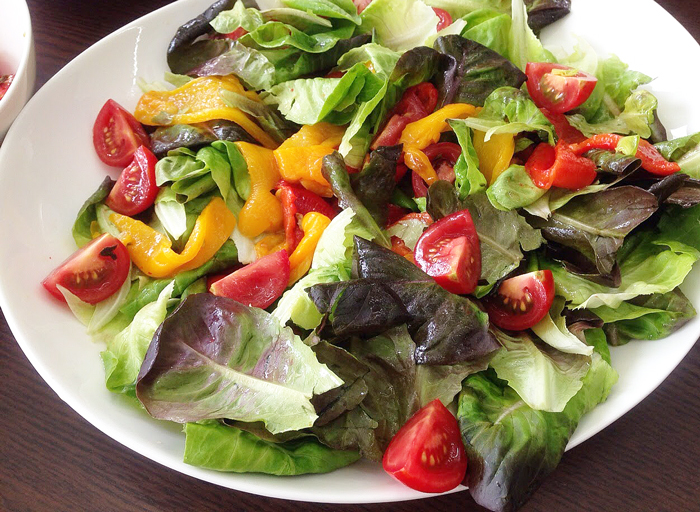 Roasted capsicum, fresh tomatoes, salad leaves with lemon olive oil dressing
