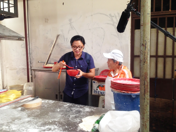 Luke tasting the freshly hand-rolled noodles by this 75 year old lady!